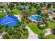 Aerial view of community splash pad and playground with picnic shelters, landscaping, sidewalks and mature palm trees at 4610 Balboa Park Loop, Lakewood Ranch, FL 34211