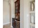 Charming bar area with wooden cabinets, a wine cooler, and decorative vases on display at 4610 Balboa Park Loop, Lakewood Ranch, FL 34211