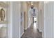 Elegant hallway with arched doorways, tiled floors, and views to the outdoor pool at 4610 Balboa Park Loop, Lakewood Ranch, FL 34211