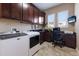 Well-equipped laundry room with modern washer and dryer, abundant cabinetry, and a functional built-in desk area at 4610 Balboa Park Loop, Lakewood Ranch, FL 34211