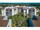 Five-story condo building featuring balconies, neutral colors and manicured grounds at 6157 Midnight Pass Rd # E43, Sarasota, FL 34242