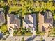 Overhead shot showcases pools and well-maintained yards, surrounded by palm trees at 6815 Turnberry Isle Ct, Lakewood Ranch, FL 34202
