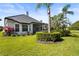 Well-maintained backyard with tropical landscaping and screened lanai at 6815 Turnberry Isle Ct, Lakewood Ranch, FL 34202