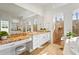 Bright bathroom features dual vanities with granite counters, walk-in shower, and soaking tub at 6815 Turnberry Isle Ct, Lakewood Ranch, FL 34202