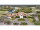 Beautiful clubhouse aerial view of the complex with elegant landscaping, fountain and a circular driveway at 6815 Turnberry Isle Ct, Lakewood Ranch, FL 34202