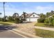 Charming home featuring a three-car garage, well-manicured landscaping, and a welcoming brick-paved driveway at 6815 Turnberry Isle Ct, Lakewood Ranch, FL 34202
