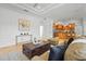 Open-concept living room with a view into the kitchen, complemented by stylish decor and ample seating at 6815 Turnberry Isle Ct, Lakewood Ranch, FL 34202