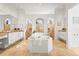 Luxurious main bathroom with a large soaking tub, dual vanities, and separate shower areas at 6815 Turnberry Isle Ct, Lakewood Ranch, FL 34202