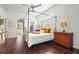 Spacious main bedroom with a four-poster bed, hardwood floors, and en-suite bathroom access at 6815 Turnberry Isle Ct, Lakewood Ranch, FL 34202