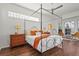 Bright main bedroom with hardwood floors, a ceiling fan, and large windows that provide natural light at 6815 Turnberry Isle Ct, Lakewood Ranch, FL 34202