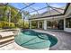 Beautiful screened-in pool and spa area with lush landscaping at 6815 Turnberry Isle Ct, Lakewood Ranch, FL 34202