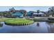 Aerial view of the clubhouse featuring inviting green space with water views at 7628 Whitebridge Gln, University Park, FL 34201