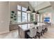 A bright kitchen featuring a large island, modern barstools, and elegant pendant lighting at 8358 Redonda Loop, Lakewood Ranch, FL 34202
