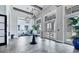 A grand entryway features high ceilings, decorative lighting, and elegant tile flooring at 8358 Redonda Loop, Lakewood Ranch, FL 34202
