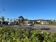 Community clubhouse with modern architecture, manicured landscaping, and ample parking on a clear day at 10109 Milky Way Cir, Sarasota, FL 34241