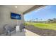 Outdoor patio with seating and a view of the community pond and palm trees at 10109 Milky Way Cir, Sarasota, FL 34241