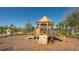Community playground with wooden play structure, climbing wall, slide, and surrounding trees on a sunny day at 10109 Milky Way Cir, Sarasota, FL 34241
