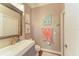 Stylish bathroom features a modern vanity, decorative mirror and artwork plus neutral wall color at 223 Heritage Isles Way, Bradenton, FL 34212
