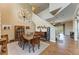 Formal dining room featuring a rustic table and chandelier, with staircase and backyard view at 223 Heritage Isles Way, Bradenton, FL 34212