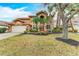 Two-story home featuring a well-manicured lawn with tropical landscaping, and a two-car garage at 223 Heritage Isles Way, Bradenton, FL 34212
