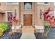 Inviting front door with decorative accents and vibrant tropical plants, set against a textured facade at 223 Heritage Isles Way, Bradenton, FL 34212