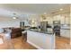 Open-concept kitchen with granite countertops, stainless steel appliances, and breakfast bar overlooking the living area at 223 Heritage Isles Way, Bradenton, FL 34212