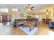 Open concept living area with wood flooring, large sofa, and view of kitchen and dining nook at 223 Heritage Isles Way, Bradenton, FL 34212