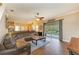 Spacious living area with wood flooring and sliding glass doors with a view of the private pool at 223 Heritage Isles Way, Bradenton, FL 34212