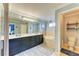Light-filled main bathroom has a double sink vanity, soaking tub, and separate toilet room at 223 Heritage Isles Way, Bradenton, FL 34212