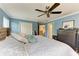 Spacious main bedroom showcases blue walls, a large bed, and ample closet space at 223 Heritage Isles Way, Bradenton, FL 34212
