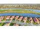 Expansive aerial view showcases a community featuring waterfront homes and a lush golf course at 23703 Waverly Cir, Venice, FL 34293