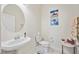 Bright half-bathroom featuring decorative paintings and fixtures at 23703 Waverly Cir, Venice, FL 34293