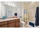 Bright bathroom featuring a granite countertop, and a tiled shower with bathtub at 23703 Waverly Cir, Venice, FL 34293