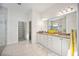 Bright bathroom featuring double sinks, granite countertops, and walk-in shower at 23703 Waverly Cir, Venice, FL 34293