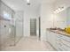 Bright bathroom featuring double sinks, granite countertops, and a glass walk-in shower at 23703 Waverly Cir, Venice, FL 34293