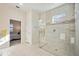 Bright bathroom featuring a glass walk-in shower and a peek at an adjacent bedroom at 23703 Waverly Cir, Venice, FL 34293