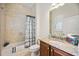Bright bathroom featuring a granite countertop, and a tiled shower with bathtub at 23703 Waverly Cir, Venice, FL 34293