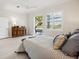 Bedroom featuring pool views, light wood floors, and a coastal-inspired color palette at 23703 Waverly Cir, Venice, FL 34293