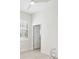 Bright bedroom featuring shuttered windows, light wood floors, and neutral paint at 23703 Waverly Cir, Venice, FL 34293