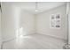 Bright, vacant bedroom featuring light wood floors and a fan at 23703 Waverly Cir, Venice, FL 34293