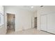Bright bedroom featuring an ensuite bathroom, light wood floors, and a closet with sliding doors at 23703 Waverly Cir, Venice, FL 34293