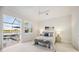 Bright bedroom featuring serene lake views, light wood floors and a coastal-inspired color palette at 23703 Waverly Cir, Venice, FL 34293