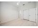 Bright bedroom featuring an ensuite bathroom, light wood floors, and a closet with sliding doors at 23703 Waverly Cir, Venice, FL 34293