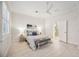 Bright bedroom featuring natural light, light wood floors and a coastal-inspired color palette at 23703 Waverly Cir, Venice, FL 34293