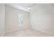 Bright, vacant bedroom featuring light wood floors and window shutters at 23703 Waverly Cir, Venice, FL 34293