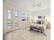 Bright bedroom featuring serene lake views, light wood floors and a coastal-inspired color palette at 23703 Waverly Cir, Venice, FL 34293