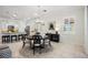 Bright dining room featuring a round table, modern chandelier, and plenty of natural light at 23703 Waverly Cir, Venice, FL 34293
