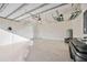 Spacious three car garage with epoxy floors and overhead storage racks at 23703 Waverly Cir, Venice, FL 34293