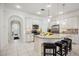 Bright kitchen featuring white cabinetry, granite countertops, stainless steel appliances, and tiled floors at 23703 Waverly Cir, Venice, FL 34293