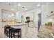 Bright kitchen featuring white cabinetry, granite countertops, stainless steel appliances, and tiled floors at 23703 Waverly Cir, Venice, FL 34293